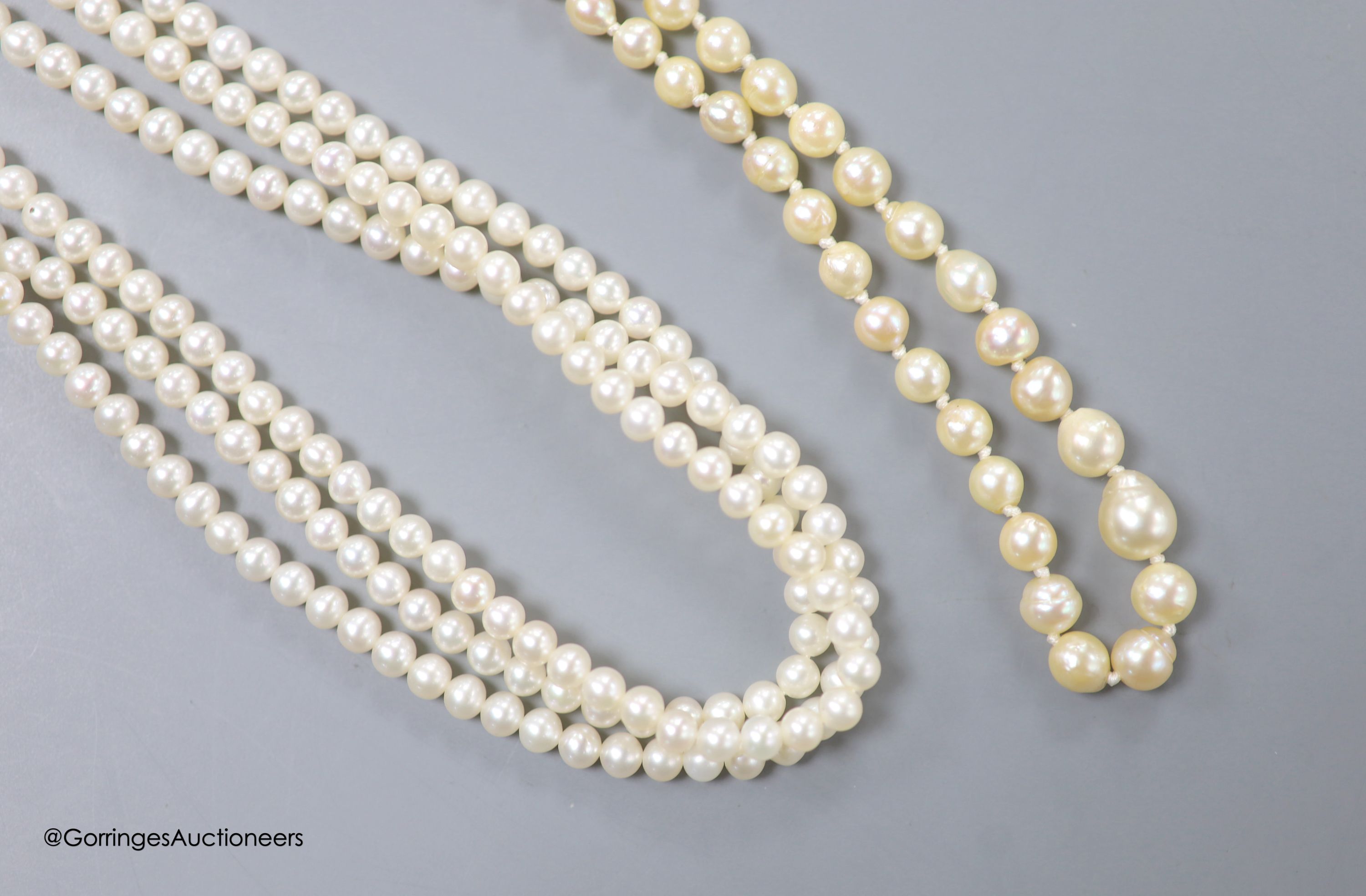 A triple strand cultured pearl choker necklace, with 375 clasp, 40cm and a single strand graduated baroque pearl necklace, with 9kt clasp, 48cm.